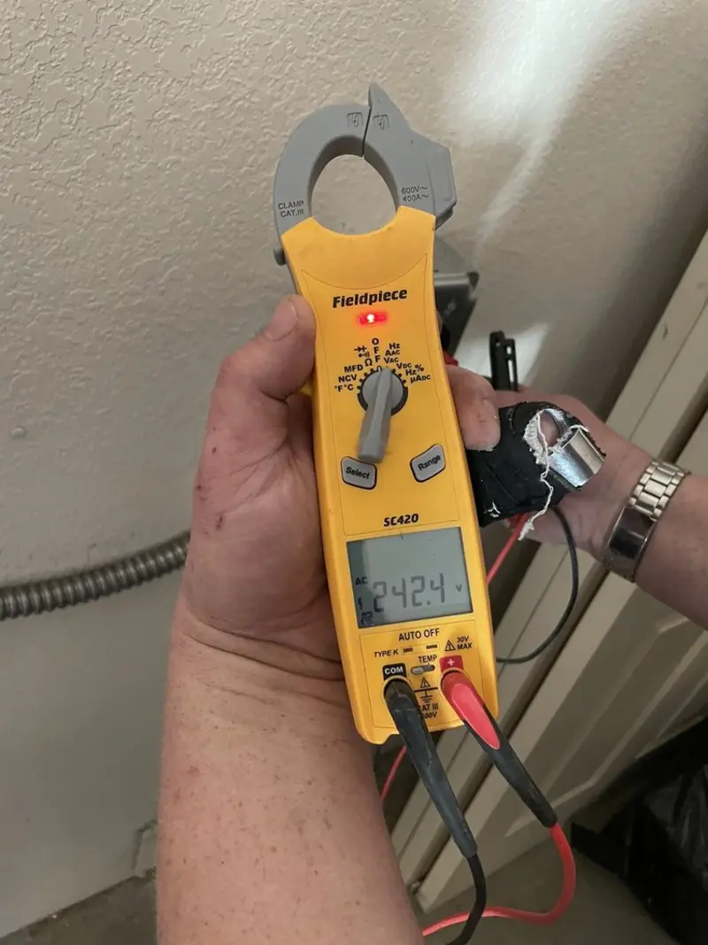 Voltage testing with clamp meter during Ceiling Fan Installation in Hockessin